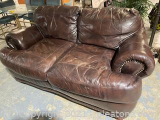 Overstuffed Leather Loveseat with Rolled Arms and Nail Head trim 