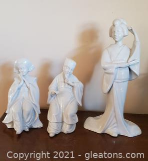 3 Beautiful Fine Porcelain Figures, 2 Women – 1 in Refined Pose- 1 Geisha with a Fan and Kimono- 1 Buddha Male 