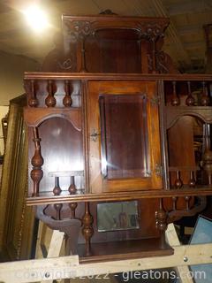 Small Antique Wooden Victorian Wall Display with Ornate Carving, Beveled Glass Door in Center and Mirror for Shelf at Bottom