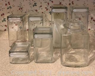 Seven Glass Lidded Canisters 
