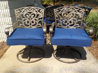 Pair of Outdoor Swivel Rocker Dining Chairs with a Navy Cushion